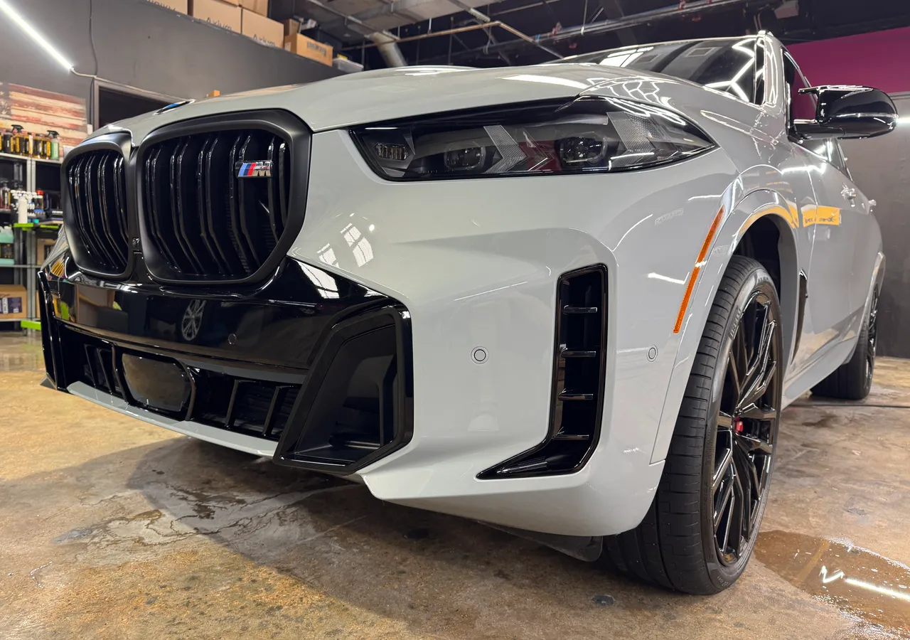 White luxury SUV under paint protection film at Protektd Detailing, Dallas