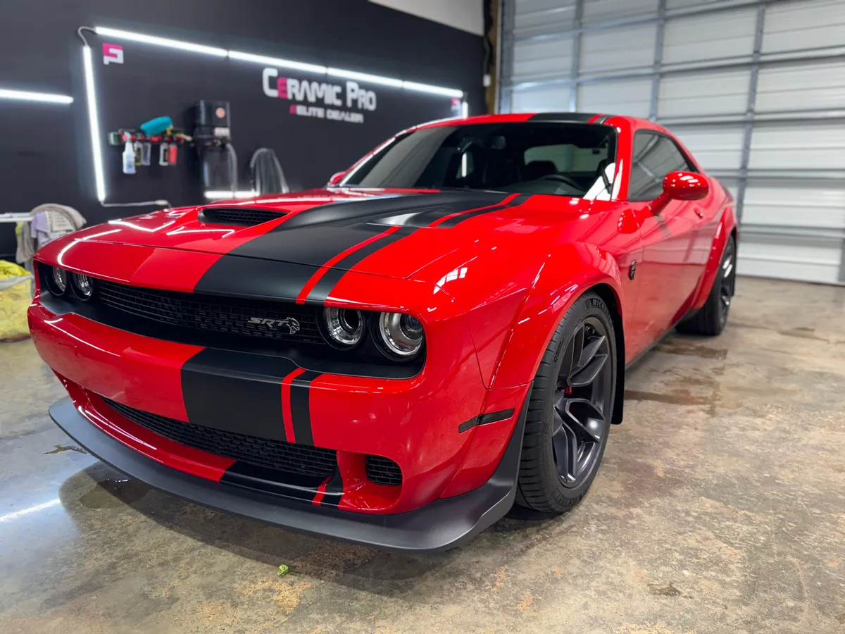 Red Dodge Challenger with racing stripes protected at Protektd Detailing, Dallas