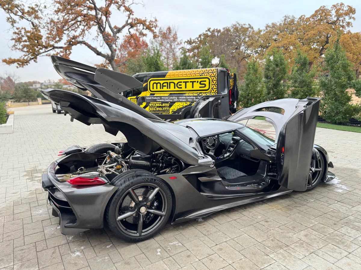 Black McLaren with doors raised in the Protektd studio for paint protection film — Dallas